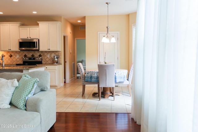 803 Urton Woods Way, Louisville, KY 40243 - kitchen with appliances with stainless steel finishes, backsplash, light stone countertops, white cabinetry, and recessed lighting