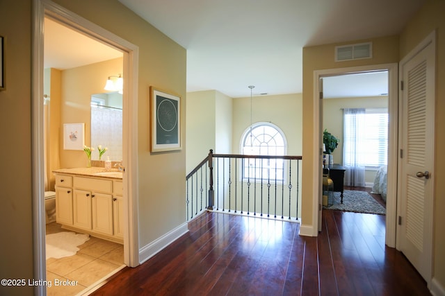 803 Urton Woods Way, Louisville, KY 40243 - hall with a sink, wood finished floors, an upstairs landing, and baseboards