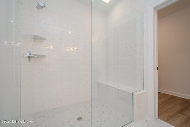 full bathroom featuring a walk in shower and wood finished floors