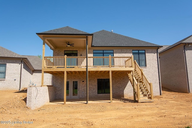 rear view of house featuring roof with shingles, stairs, french doors, brick siding, and a ceiling fan