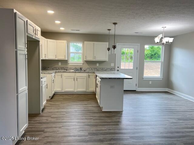 5415 Mount Holyoke Dr, Louisville, KY 40216 - kitchen with a peninsula, recessed lighting, plenty of natural light, a chandelier, and dark wood-type flooring