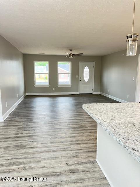 5415 Mount Holyoke Dr, Louisville, KY 40216 - unfurnished living room with baseboards, ceiling fan, and wood finished floors