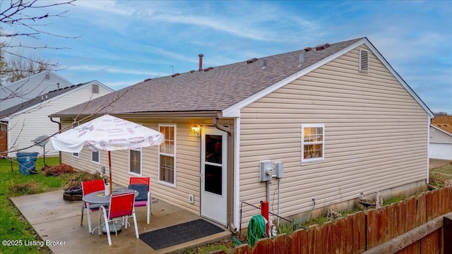 1312 Cedar Springs Pkwy, La Grange, KY 40031 - rear view of house featuring a fire pit, a patio area, roof with shingles, and fence