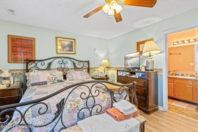 1312 Cedar Springs Pkwy, La Grange, KY 40031 - bedroom with a ceiling fan, ensuite bathroom, visible vents, a sink, and light wood-type flooring