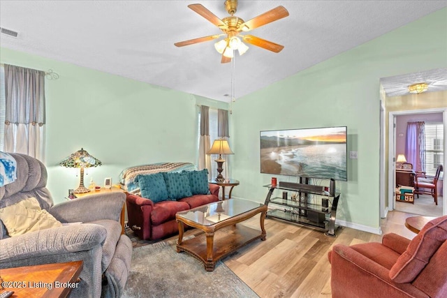 1312 Cedar Springs Pkwy, La Grange, KY 40031 - living room with wood finished floors, visible vents, vaulted ceiling, a ceiling fan, and baseboards