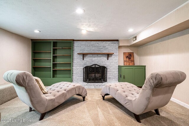 living area with carpet, a textured ceiling, recessed lighting, a fireplace, and baseboards