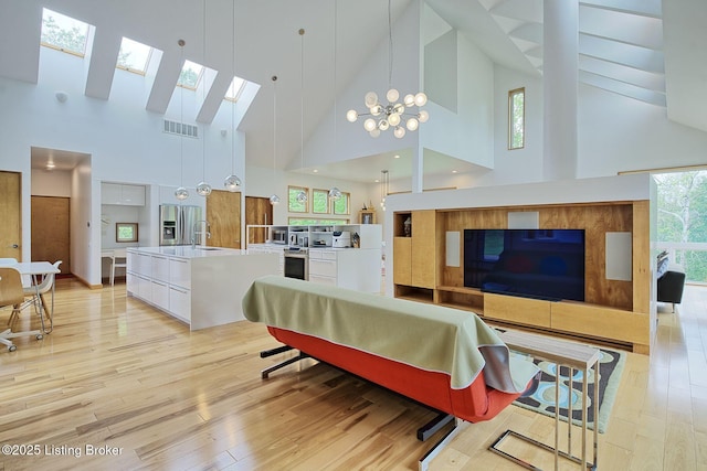 1301 S Buckeye Ln, Goshen, KY 40026 - living room with high vaulted ceiling, a skylight, and light wood finished floors