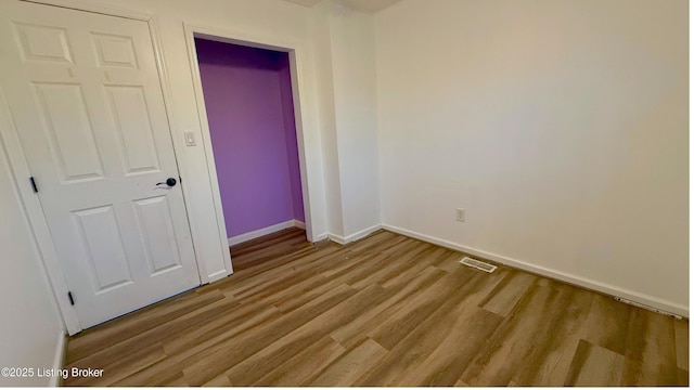 5013 Tolkien Ct, Louisville, KY 40229 - unfurnished bedroom featuring baseboards, a closet, visible vents, and wood finished floors