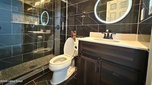 5013 Tolkien Ct, Louisville, KY 40229 - bathroom featuring tile walls, toilet, a tile shower, vanity, and decorative backsplash