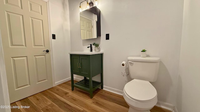 5013 Tolkien Ct, Louisville, KY 40229 - bathroom with vanity, toilet, wood finished floors, and baseboards