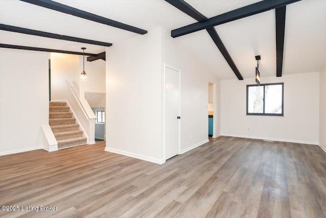4804 Mike Ct, Louisville, KY 40291 - unfurnished living room featuring baseboards, stairway, vaulted ceiling with beams, and wood finished floors