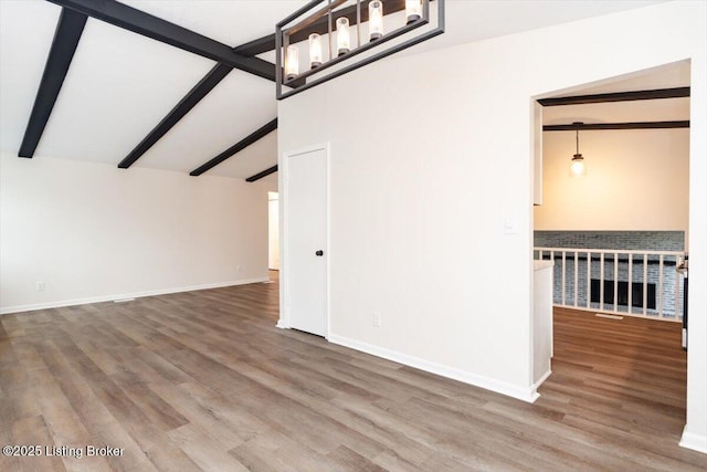 4804 Mike Ct, Louisville, KY 40291 - unfurnished living room with baseboards, vaulted ceiling with beams, and wood finished floors