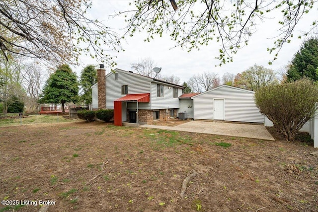 4804 Mike Ct, Louisville, KY 40291 - rear view of property with brick siding, an outbuilding, a chimney, and a patio