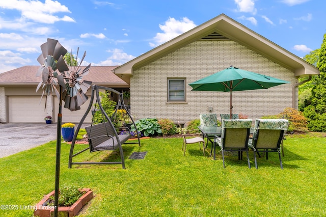 view of green lawn featuring a garage