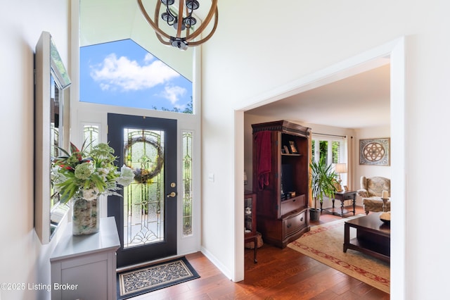 entrance foyer featuring wood finished floors and a chandelier
