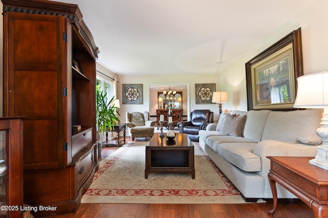 living room with a chandelier and wood finished floors