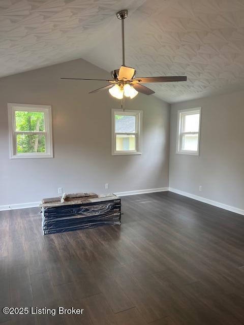 6100 Deady Dr, Louisville, KY 40258 - empty room with baseboards, vaulted ceiling, a ceiling fan, and dark wood-style floors