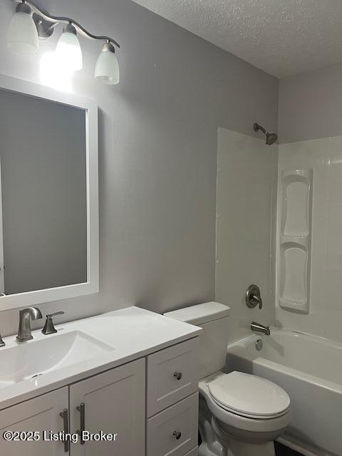 6100 Deady Dr, Louisville, KY 40258 - bathroom with a textured ceiling, toilet, vanity, and bathtub / shower combination