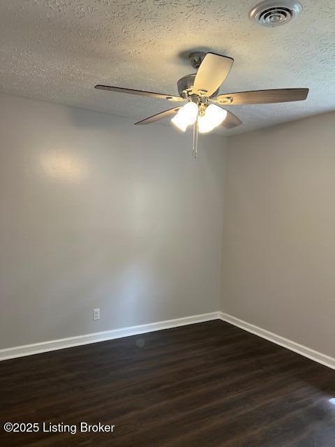 6100 Deady Dr, Louisville, KY 40258 - spare room featuring a ceiling fan, dark wood-type flooring, baseboards, and a textured ceiling