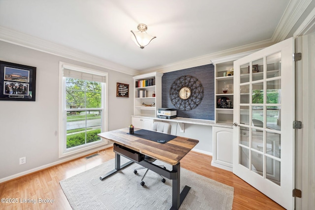 office space featuring ornamental molding, light wood-style flooring, and baseboards