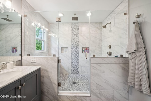 bathroom with a shower stall and vanity