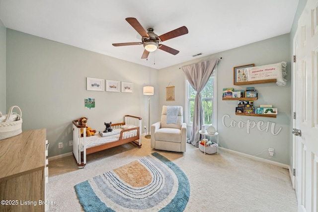 carpeted bedroom with baseboards and a ceiling fan