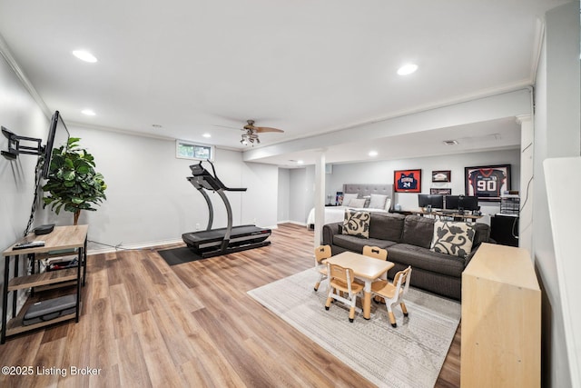 living area featuring wood finished floors, ornamental molding, recessed lighting, ceiling fan, and baseboards