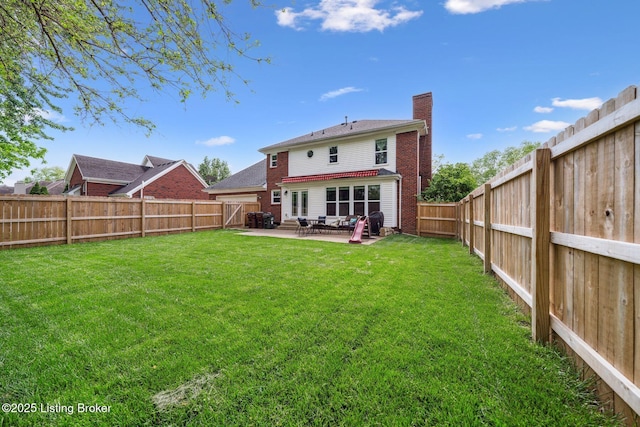 rear view of property with a chimney, a patio area, and brick siding