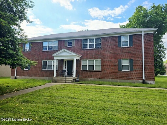view of front of home featuring brick siding and a front yard
