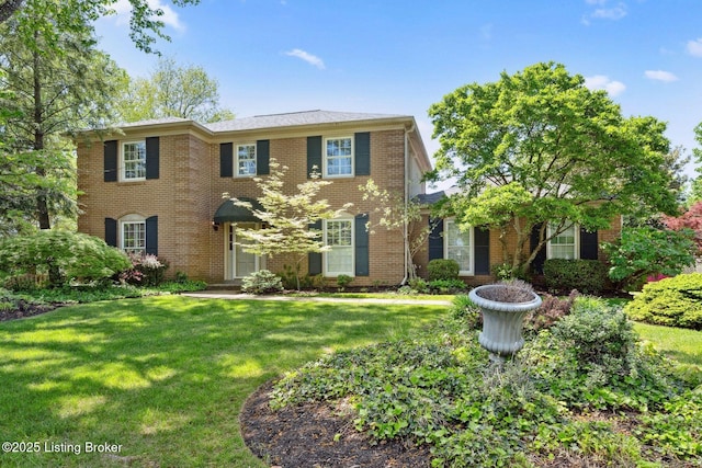 view of front facade featuring a front lawn and brick siding
