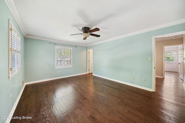 empty room with ceiling fan, wood finished floors, baseboards, and crown molding
