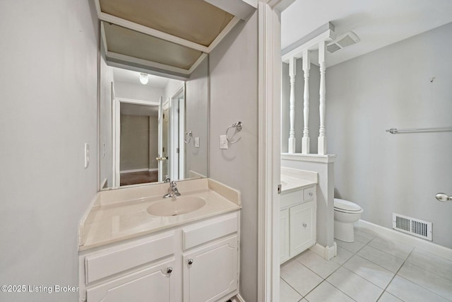 bathroom featuring vanity, tile patterned floors, toilet, and baseboards
