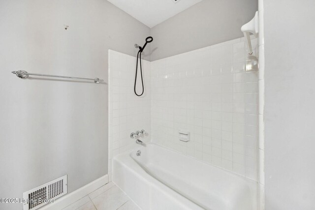 bathroom with tile patterned floors, baseboards, and shower / tub combination