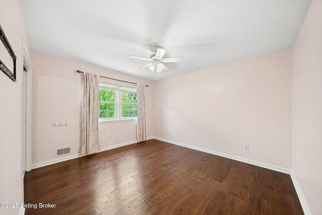 empty room with wood finished floors, baseboards, and ceiling fan