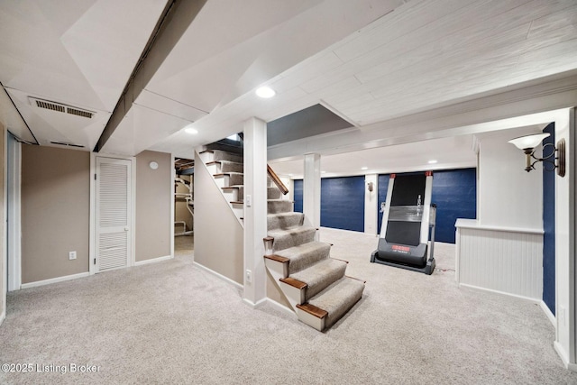 finished below grade area featuring carpet flooring, stairs, baseboards, and recessed lighting