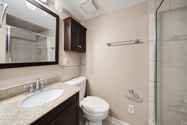 full bath featuring a stall shower, toilet, and vanity