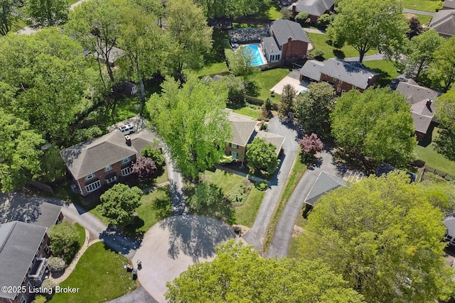 aerial overview of property's location with nearby suburban area and a pool area