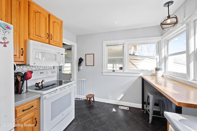 17 Denham Rd, Louisville, KY 40205 - kitchen featuring white appliances, light countertops, baseboards, dark tile patterned flooring, and hanging light fixtures