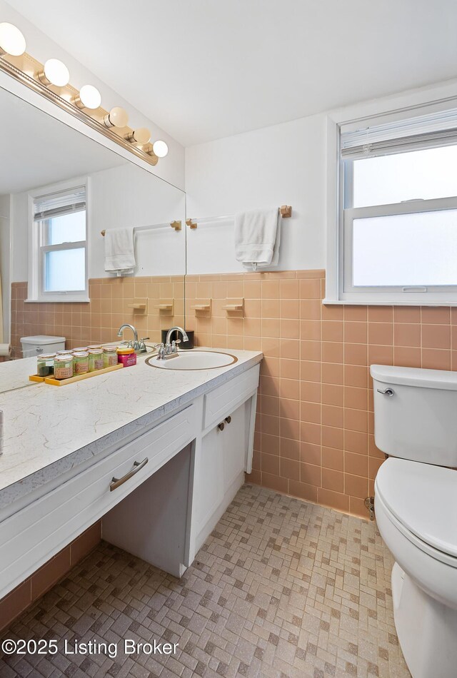17 Denham Rd, Louisville, KY 40205 - bathroom with toilet, tile walls, vanity, and wainscoting