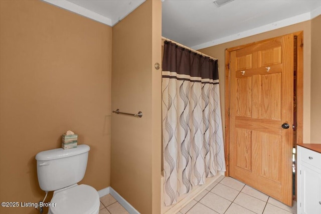 full bathroom with tile patterned floors, toilet, curtained shower, and baseboards
