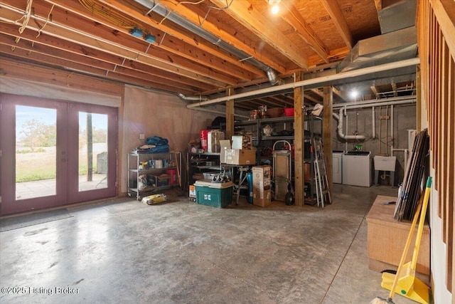 below grade area with independent washer and dryer, a sink, and french doors