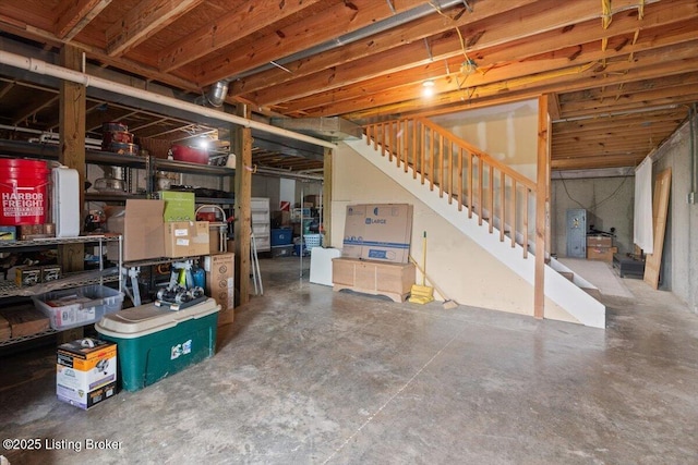 unfinished below grade area featuring stairs