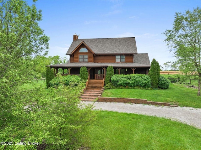 log home featuring a chimney, driveway, a front yard, and stairway
