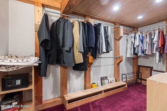 walk in closet with carpet