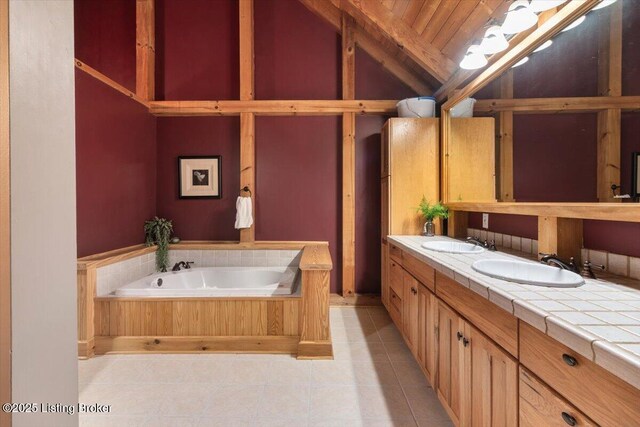 full bath with lofted ceiling, tile patterned floors, a garden tub, double vanity, and wood ceiling