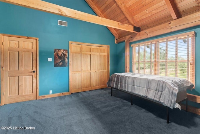 bedroom with carpet, wood ceiling, baseboards, and a closet