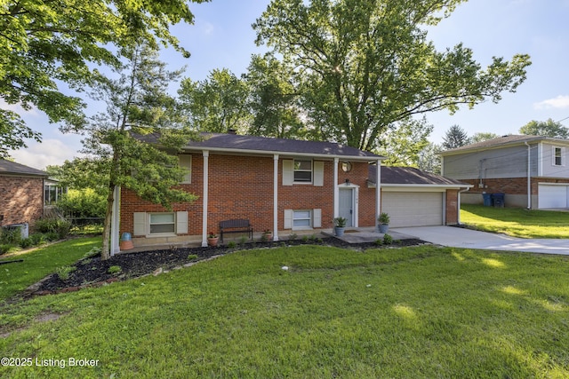 bi-level home featuring concrete driveway, brick siding, a front yard, and an attached garage