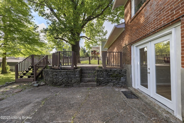 view of patio with stairway, a deck, and french doors