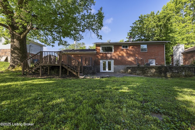 rear view of property with stairs, french doors, a lawn, and a deck