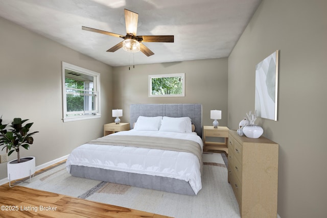 bedroom featuring baseboards and ceiling fan
